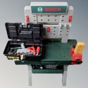 A child's toy Bosch work bench together with Stanley tool box containing assorted plastic tools and