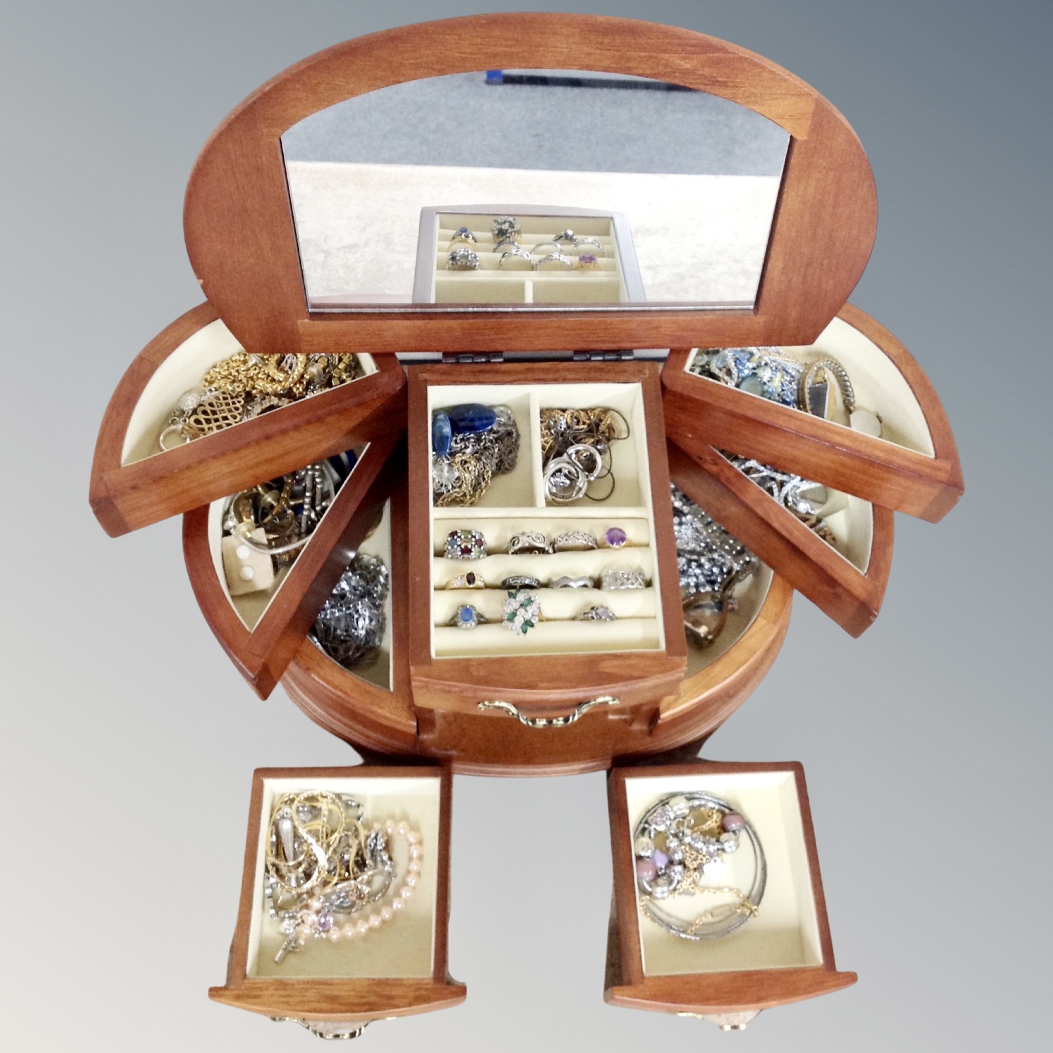 A contemporary D-shaped table topped jewellery chest containing good quality costume and silver