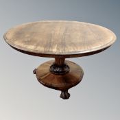 A Victorian rosewood pedestal breakfast table on lion paw feet,