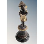 A patinated brass figure of an angel on polished socle,