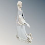 A Lladro figure of a lady holding a goose