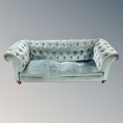 A late Victorian Chesterfield settee in turquoise buttoned fabric