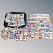 A tray of assorted Pokemon and Yu-Gi-Oh! cards