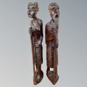 A pair of carved rustic wooden tribal figures,