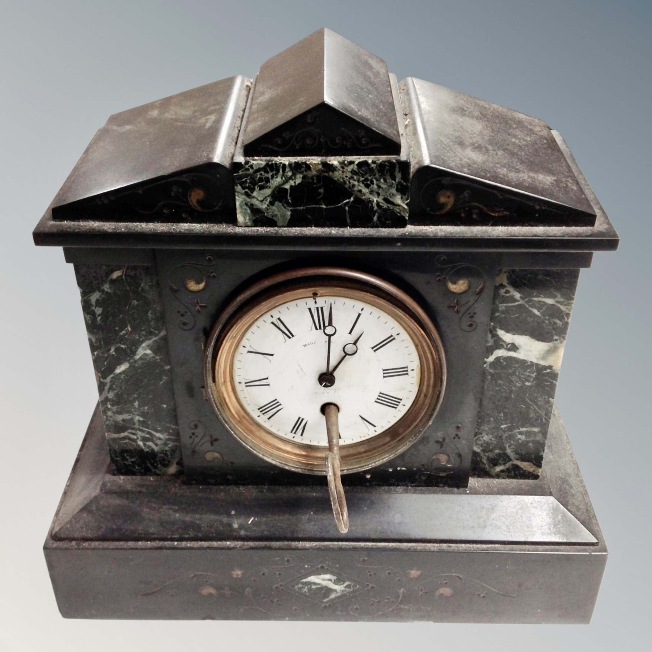 A Victorian black slate and marble mantel clock with key