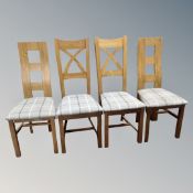 A contemporary oak pull out dining table together with two sets of four high backed chairs