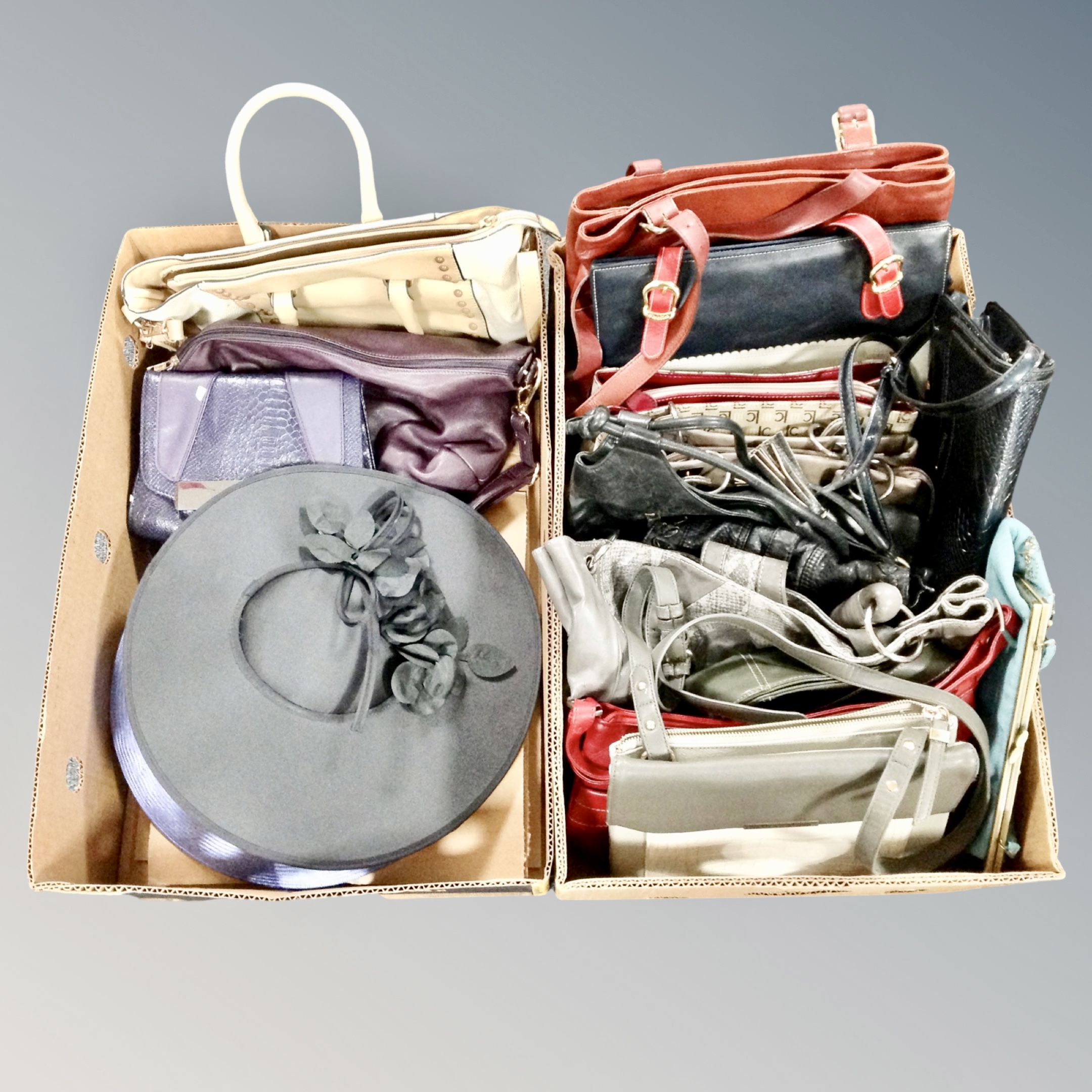 Two boxes of assorted hand bags and lady's formal hats