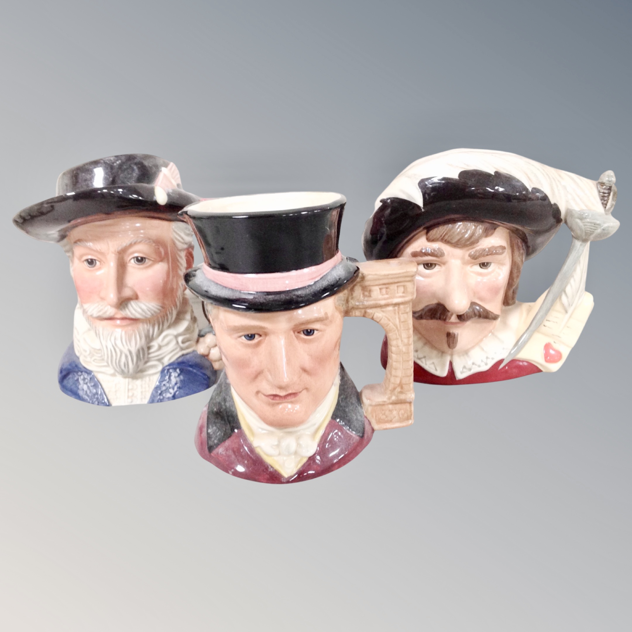 Three Royal Doulton character jugs : Cyrano de Bergerac, Sir Walter Raleigh,