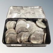 A vintage tin money box containing 50 assorted crowns