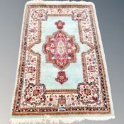 An Eastern rug on turquoise ground,