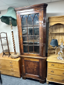 A Victorian stained pine glazed corner cabinet
