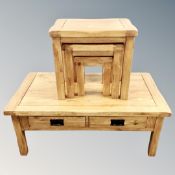 A contemporary solid oak nest of three tables and similar two drawer low coffee table,