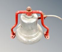 A vintage fire bell on bracket.