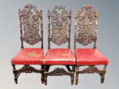 Three heavily carved oak Continental dining chairs