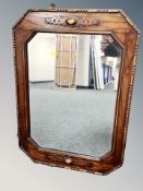 An Edwardian oak bevelled mirror 73 cm x 51 cm