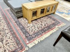 A machine made rug of Persian design,