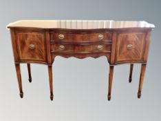 A reproduction serpentine fronted inlaid mahogany sideboard,
