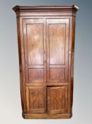 An early 19th century mahogany corner cabinet