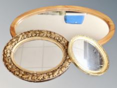 An oval pine mirror together with two further oval mirrors