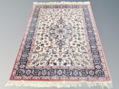 A machine made carpet of Persian design,