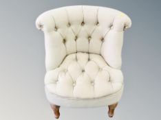 A contemporary buttoned cloth bedroom chair
