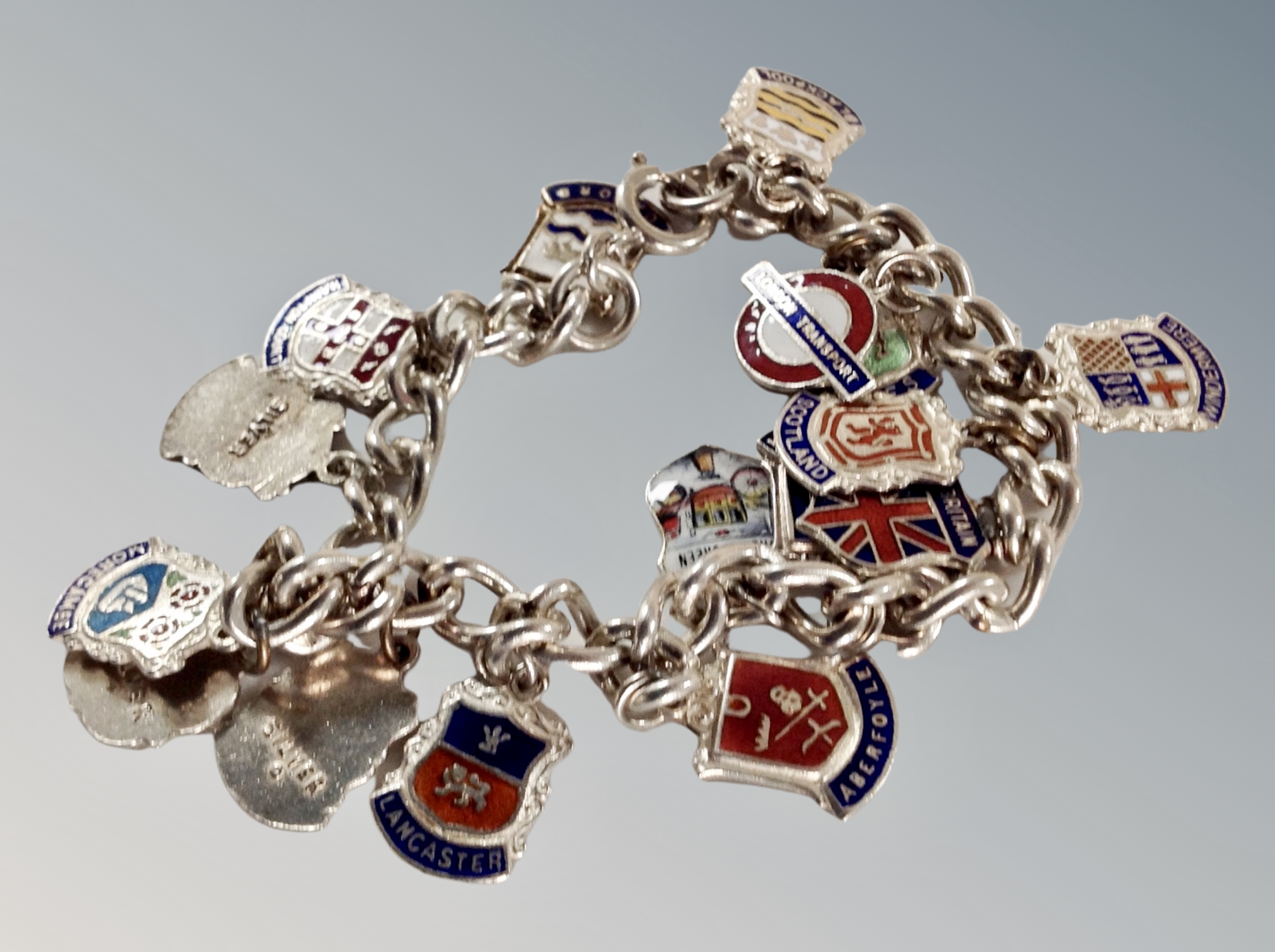 A silver bracelet with crests