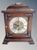 A reproduction bracket clock with silvered dial,