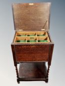 An Edwardian oak sewing cabinet with lift up top, width 50 cm.