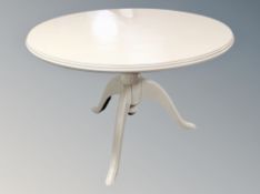 A contemporary white pedestal circular table together with three Victorian style dining chairs and