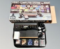 An Atari Video Computer system together with Space Invaders, Night Driver, Asteroids,