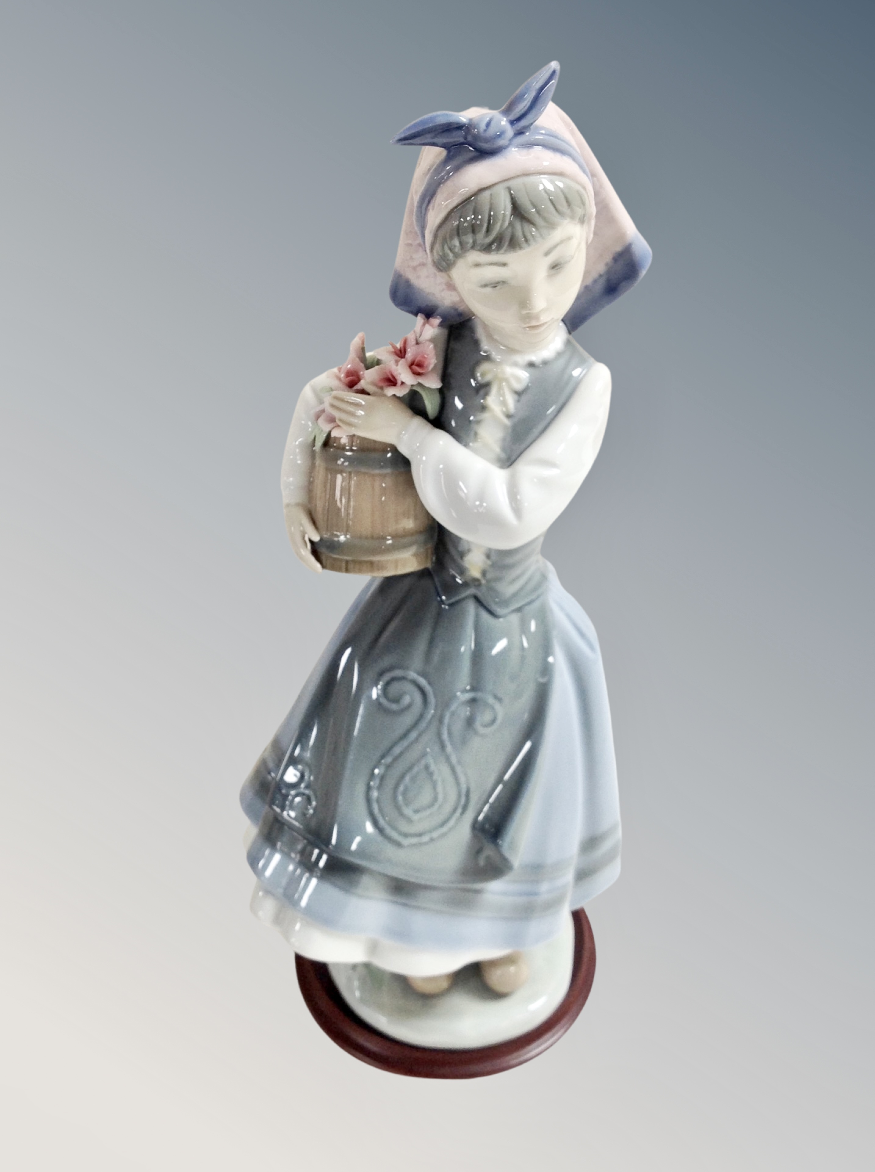 A Ladro figure of a girl carrying pail of flowers