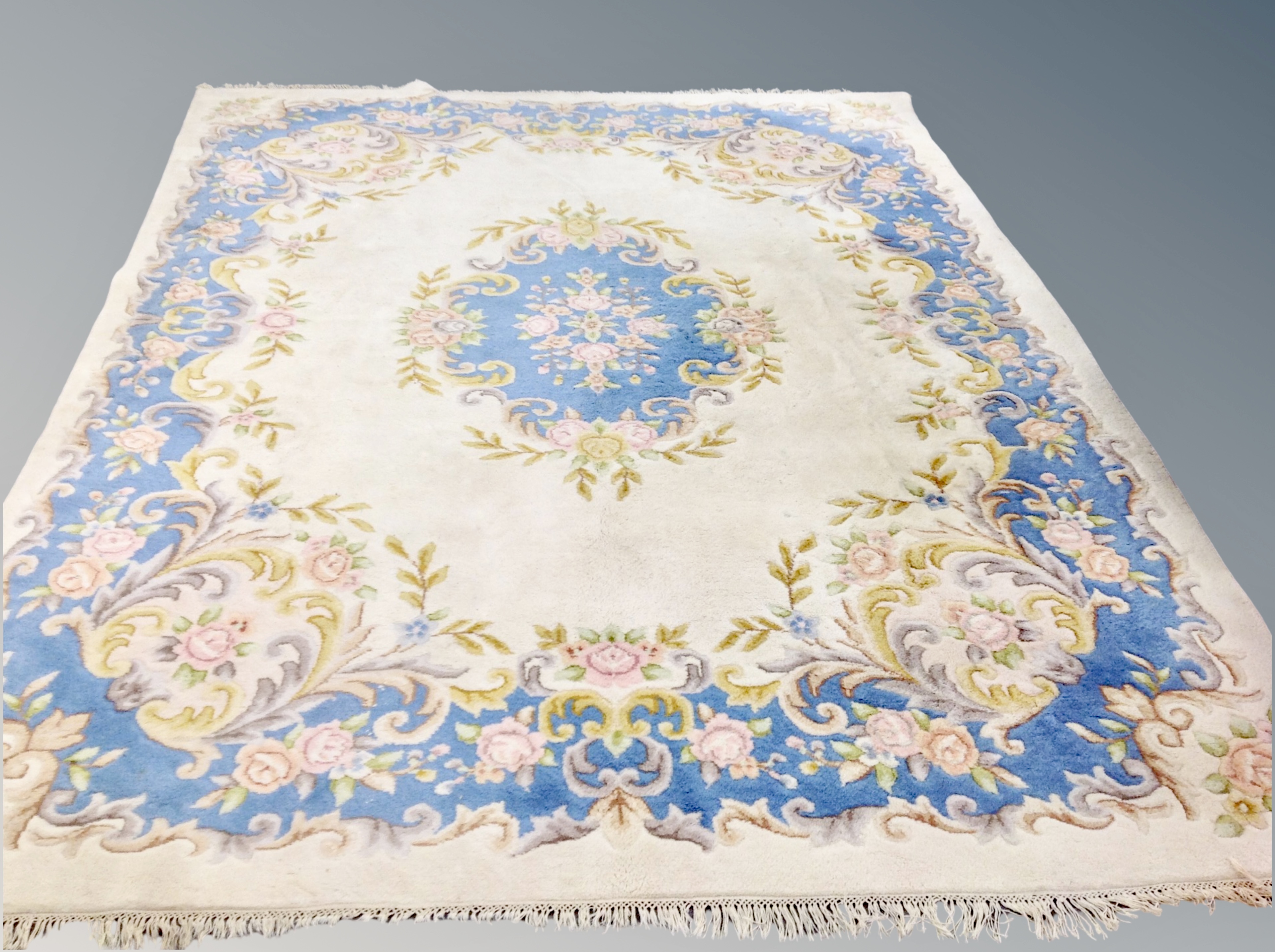 A Chinese floral carpet on blue and cream ground 280 cm x 360 cm