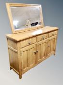 A contemporary oak sideboard fitted with three drawers,