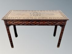A George III and later carved oak side table,