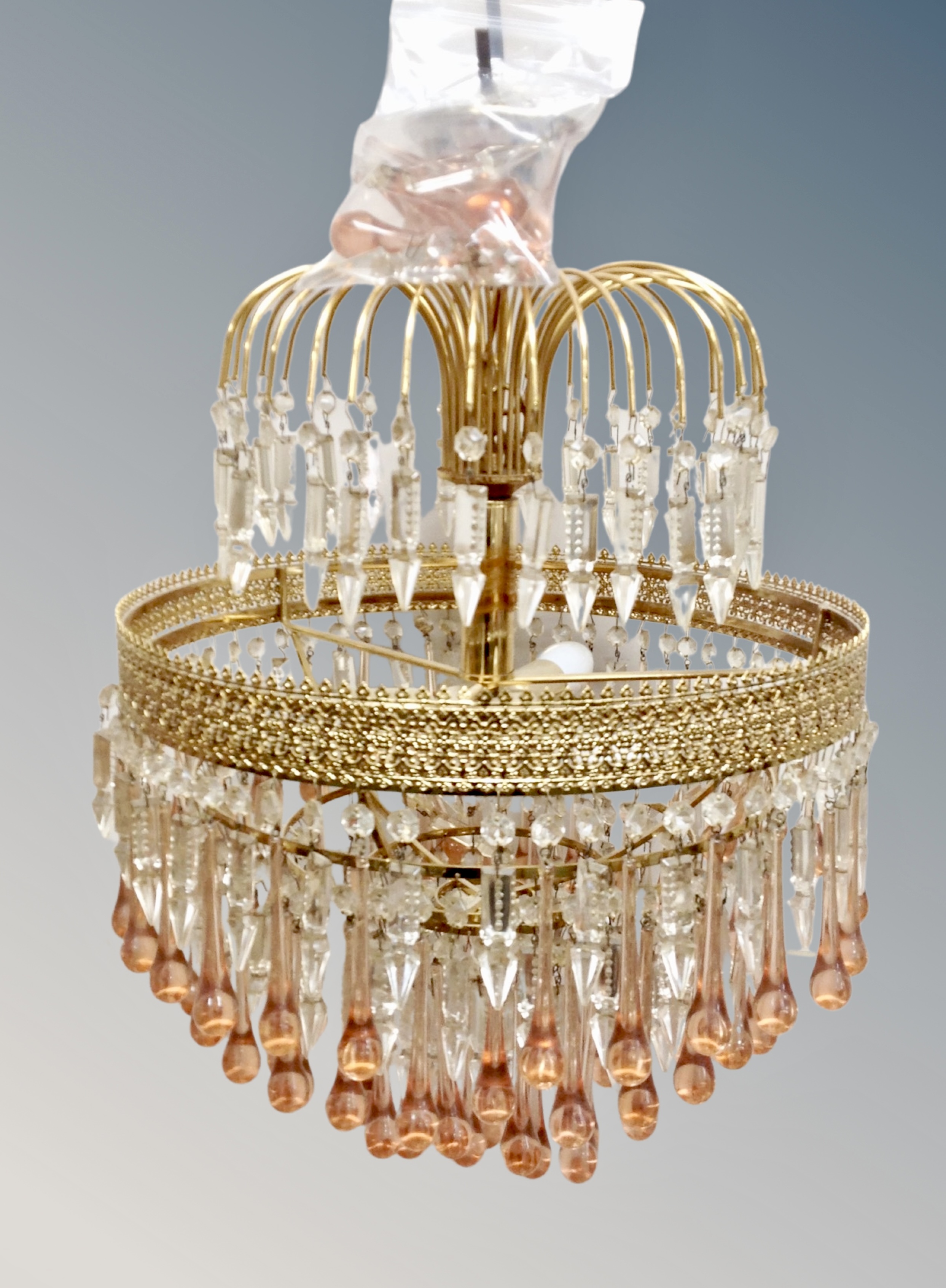 A continental gilt metal and two tone crystal pendant light fitting, wired for electricity,