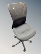 A black mesh swivel typist's chair
