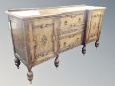 An Edwardian oak inverted breakfronted sideboard,