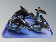 Four Poole pottery dolphin ornaments