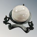 A 3" diameter polished marble globe on patinated stand