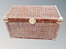 A wicker storage box with metal mounts,