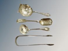 A set of Georgian silver sugar tongs, two spoons and a sifter.