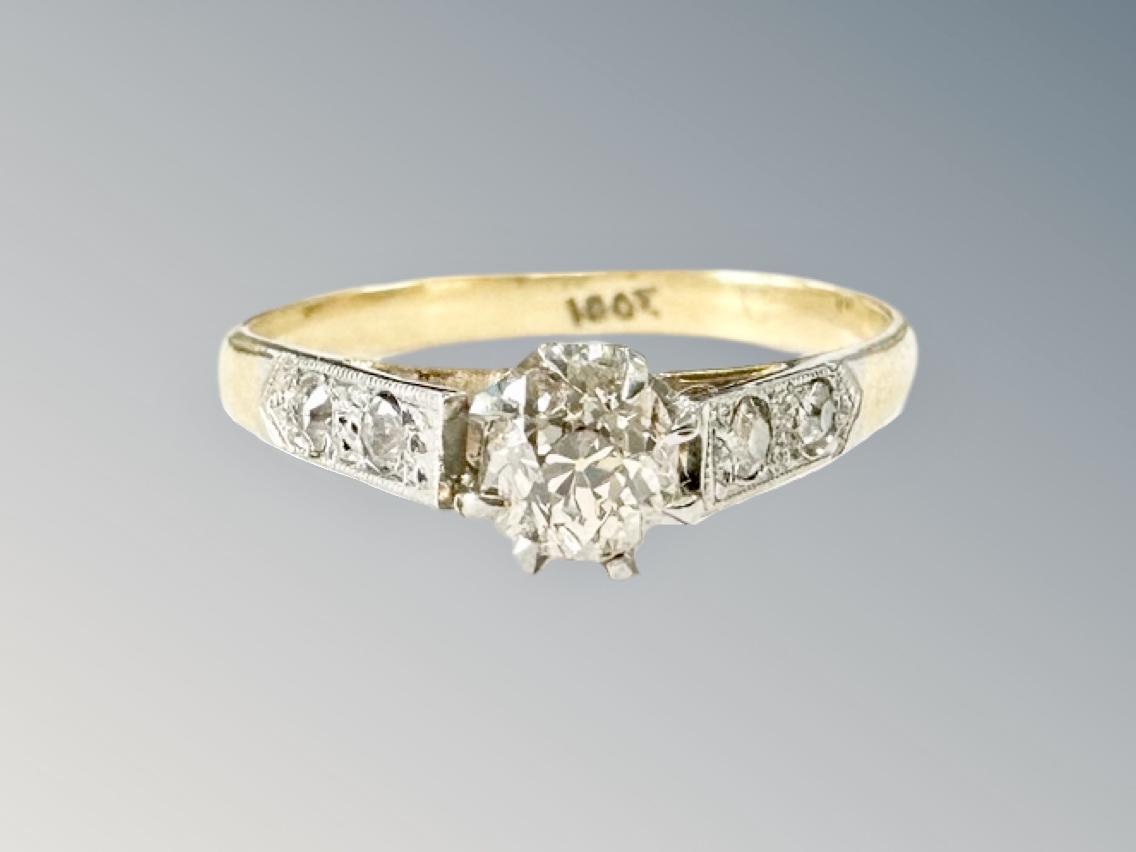 An 18ct gold diamond solitaire ring, the old-cut stone weighing approximately 0.25 carat, size K.