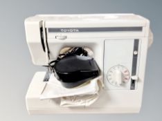 A Toyota sewing machine model EX1 with foot pedal and lead.