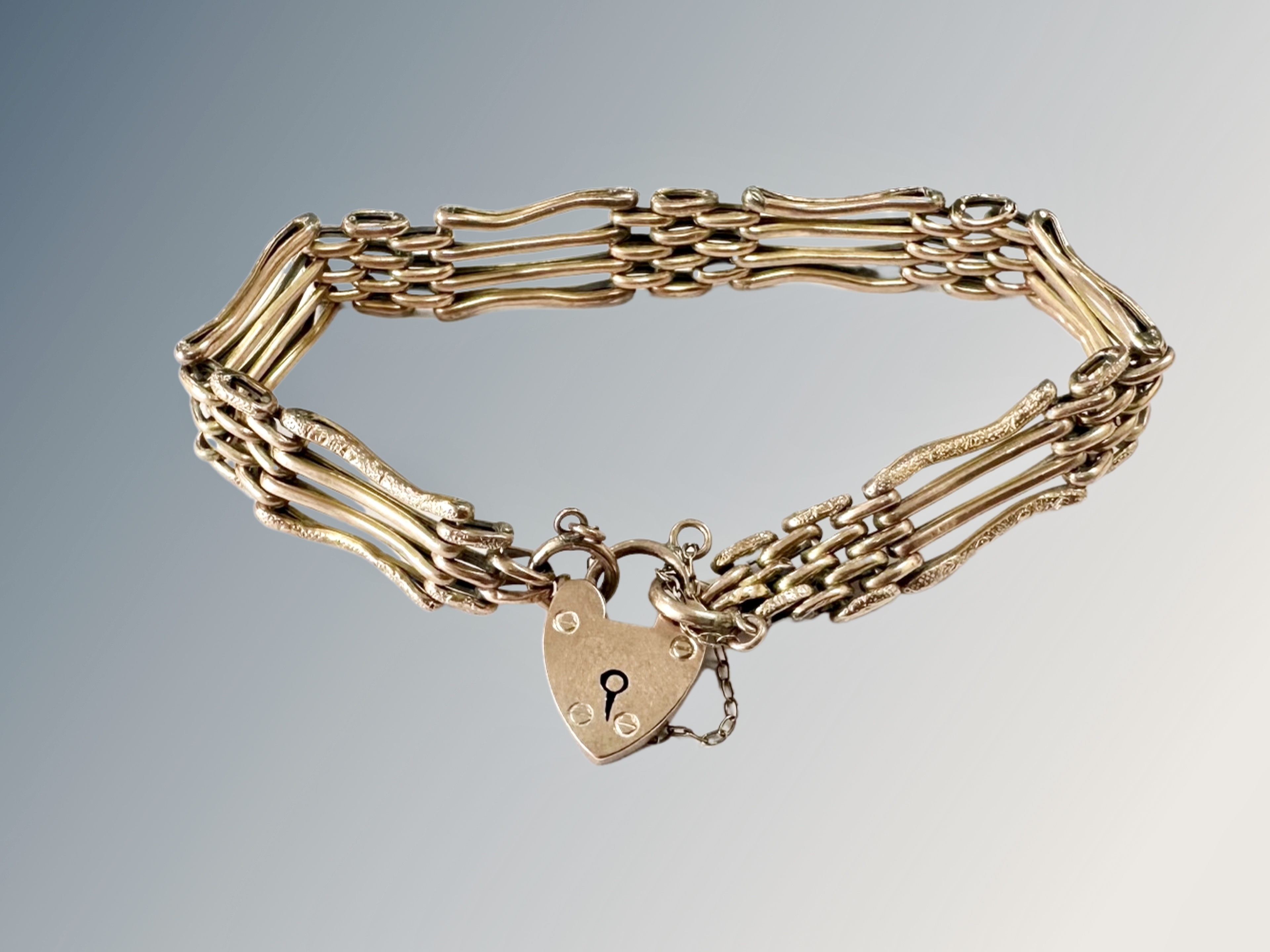 A 9ct gold padlock bracelet CONDITION REPORT: 8.