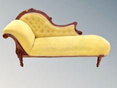 An Edwardian chaise longue upholstered in mustard fabric,