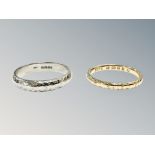 An 18ct yellow gold band ring and similar 18ct white gold band ring in textured finish,