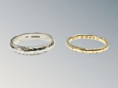 An 18ct yellow gold band ring and similar 18ct white gold band ring in textured finish,