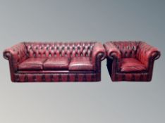 A red leather Chestefield three seater settee with matching armchair CONDITION REPORT: