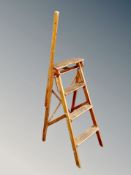 A metal adjustable step ladder