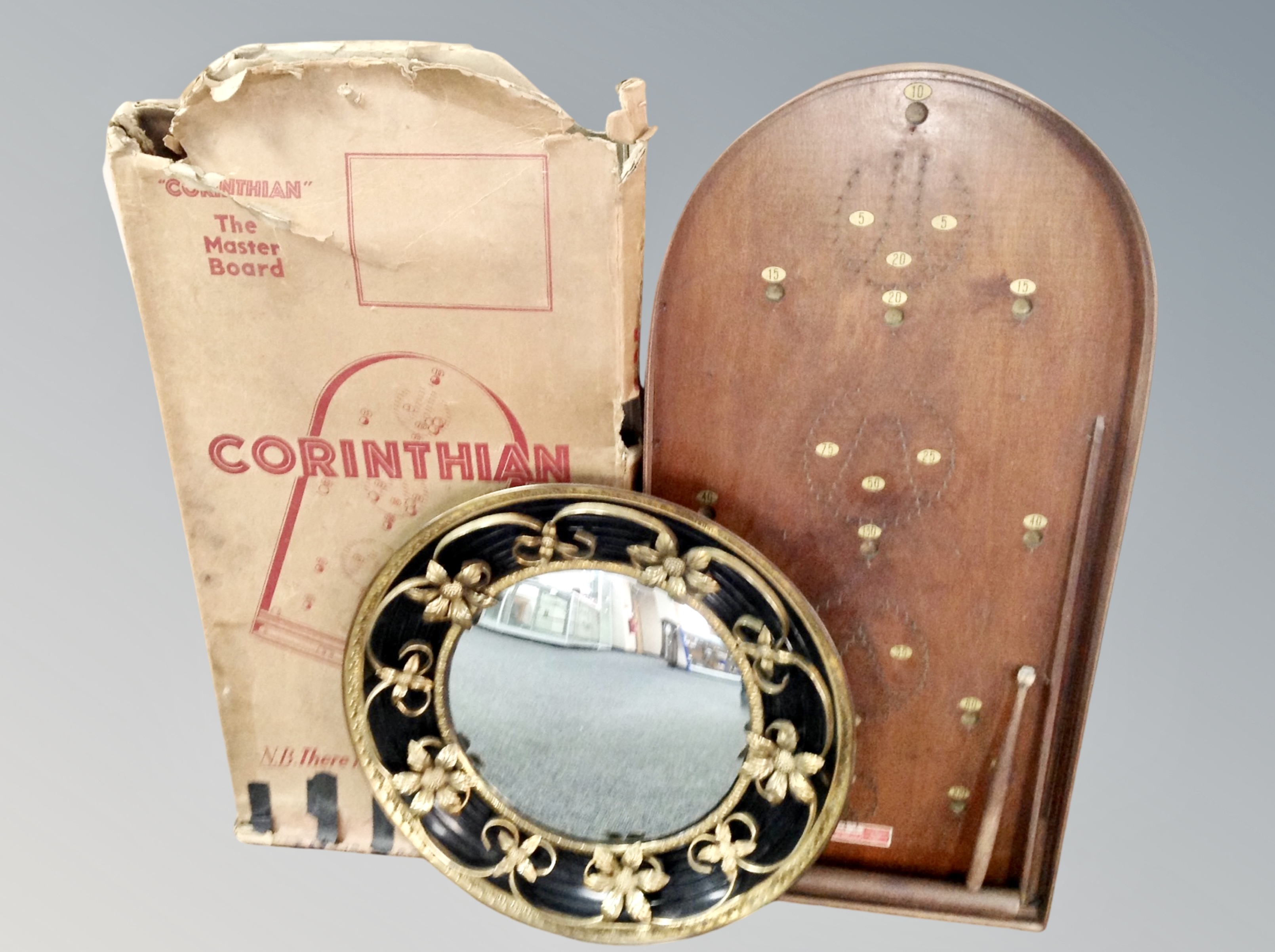 A gilt framed porthole mirror and a bagatelle board